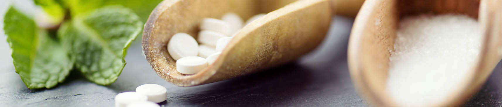 Sugar substitutes – Stevia, Erythritol and Xylitol in different forms shot on slate